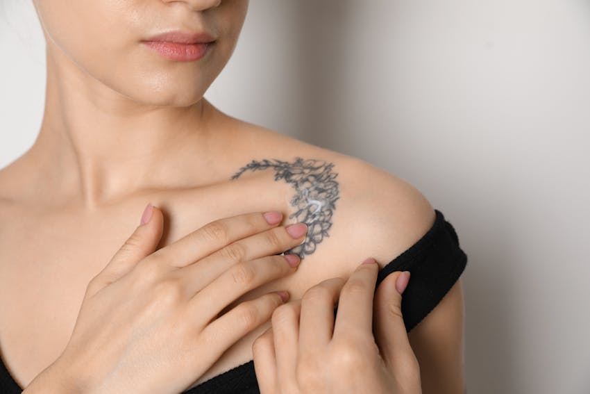 woman with floral moon tattoo