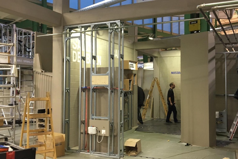 The trade fair booth stood out particularly due to ist special design in the construction site look and the shiny pipes
