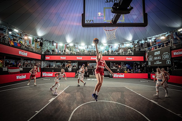 An Austrian player making a layup at the FIBA 3x3 tournament at the Thunderdome Arena in Graz