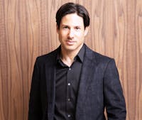 Dr. Cohen in dark shirt and sport coat. 