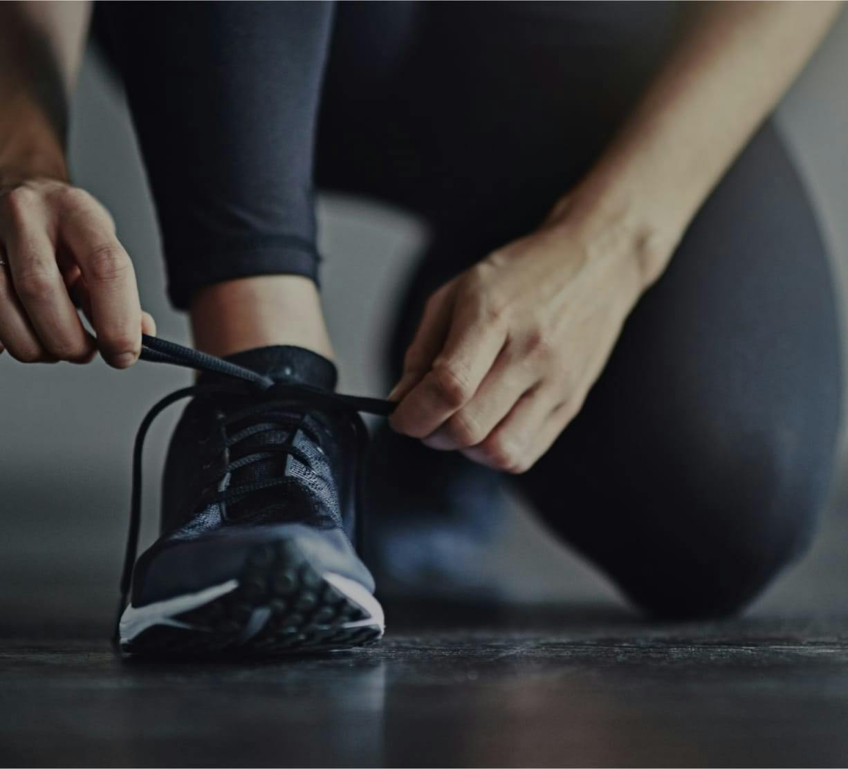 person tying their shoes