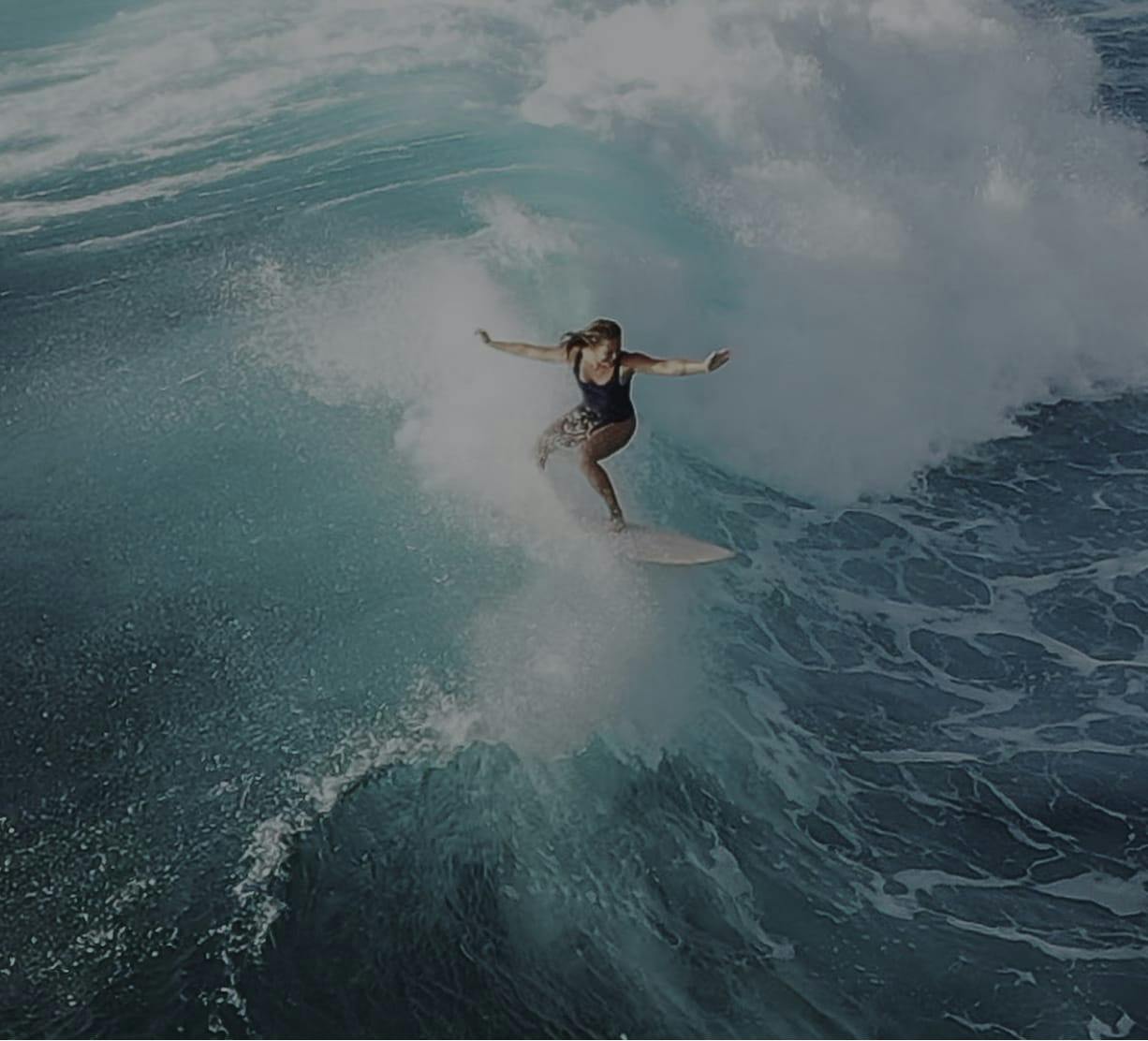 woman surfing on a wave