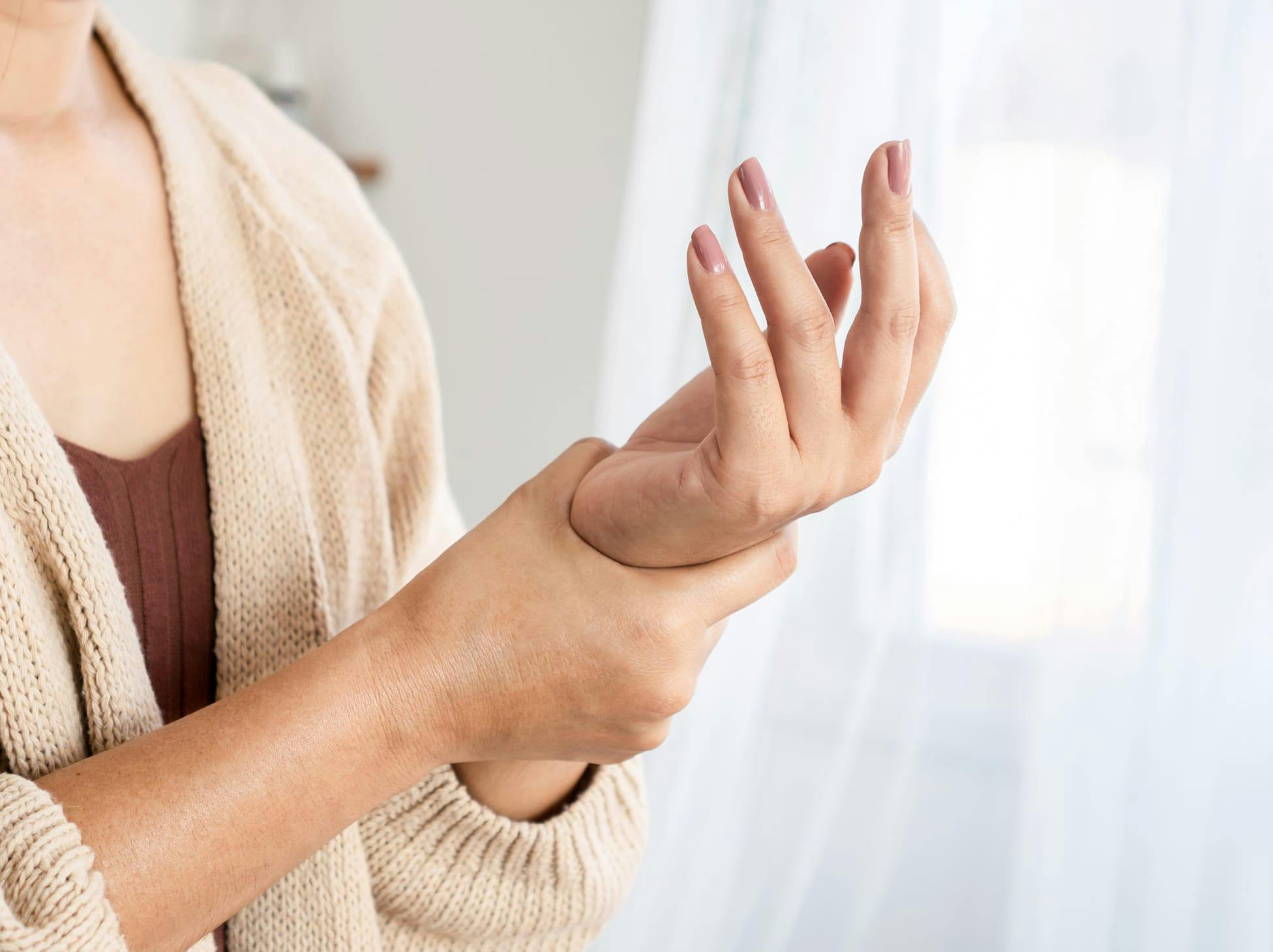 woman holding her wrist