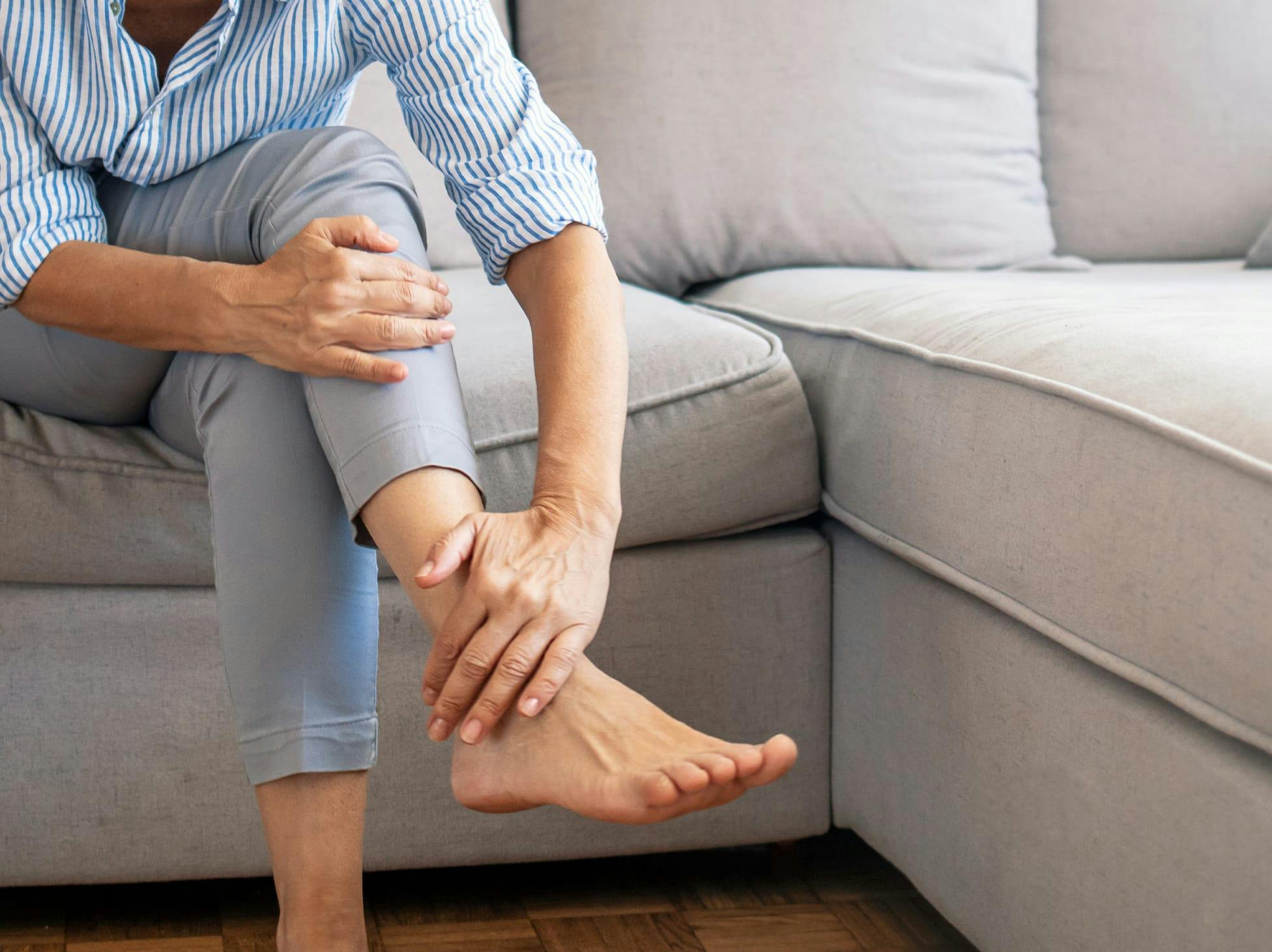 woman holding her ankle