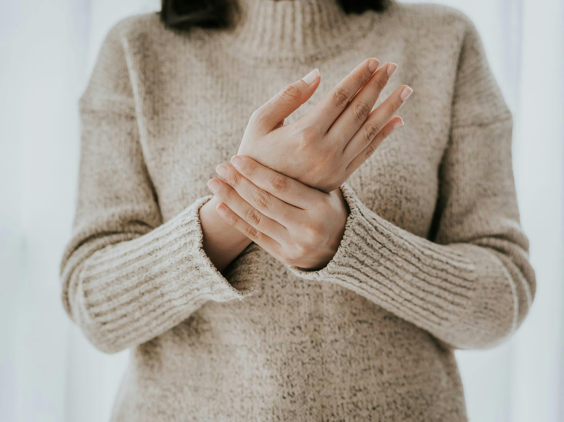 woman holding her wrist