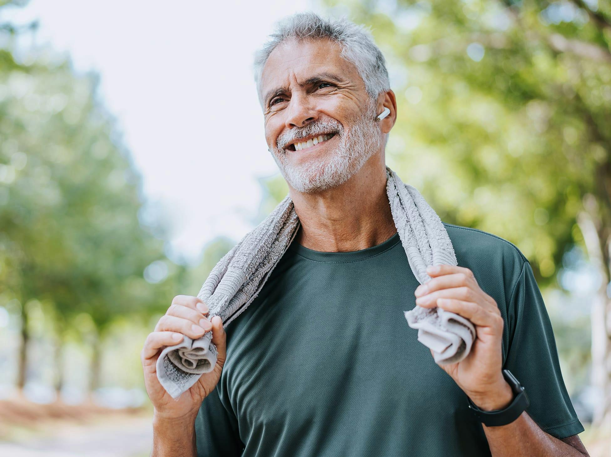man holding a towel on his shoulders