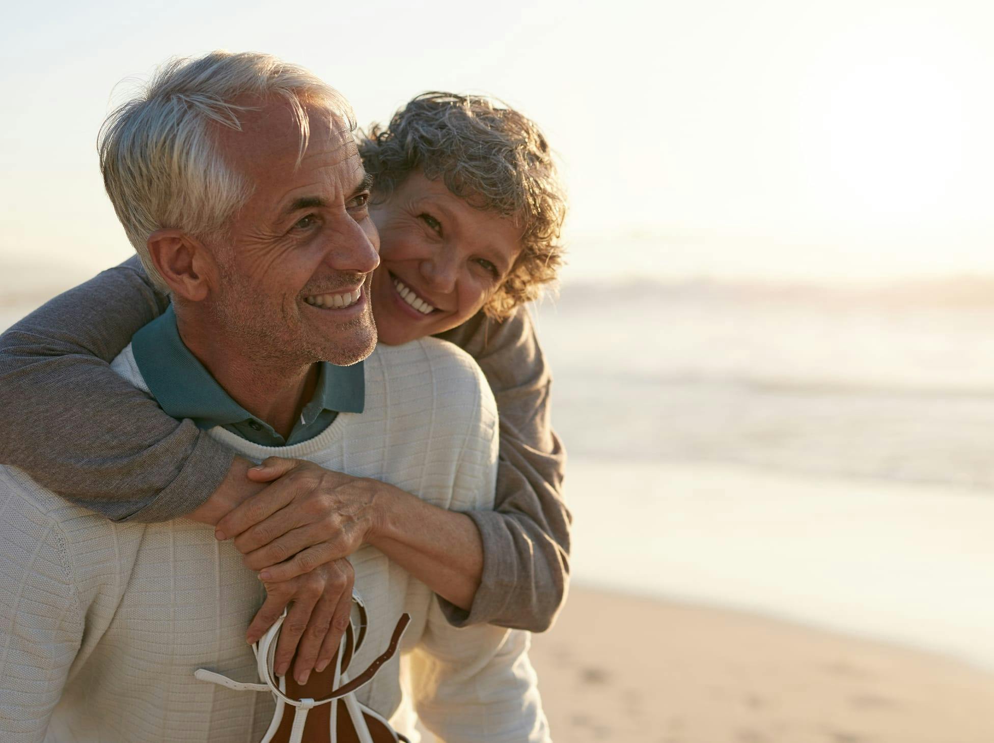 older woman hugging older man from behind