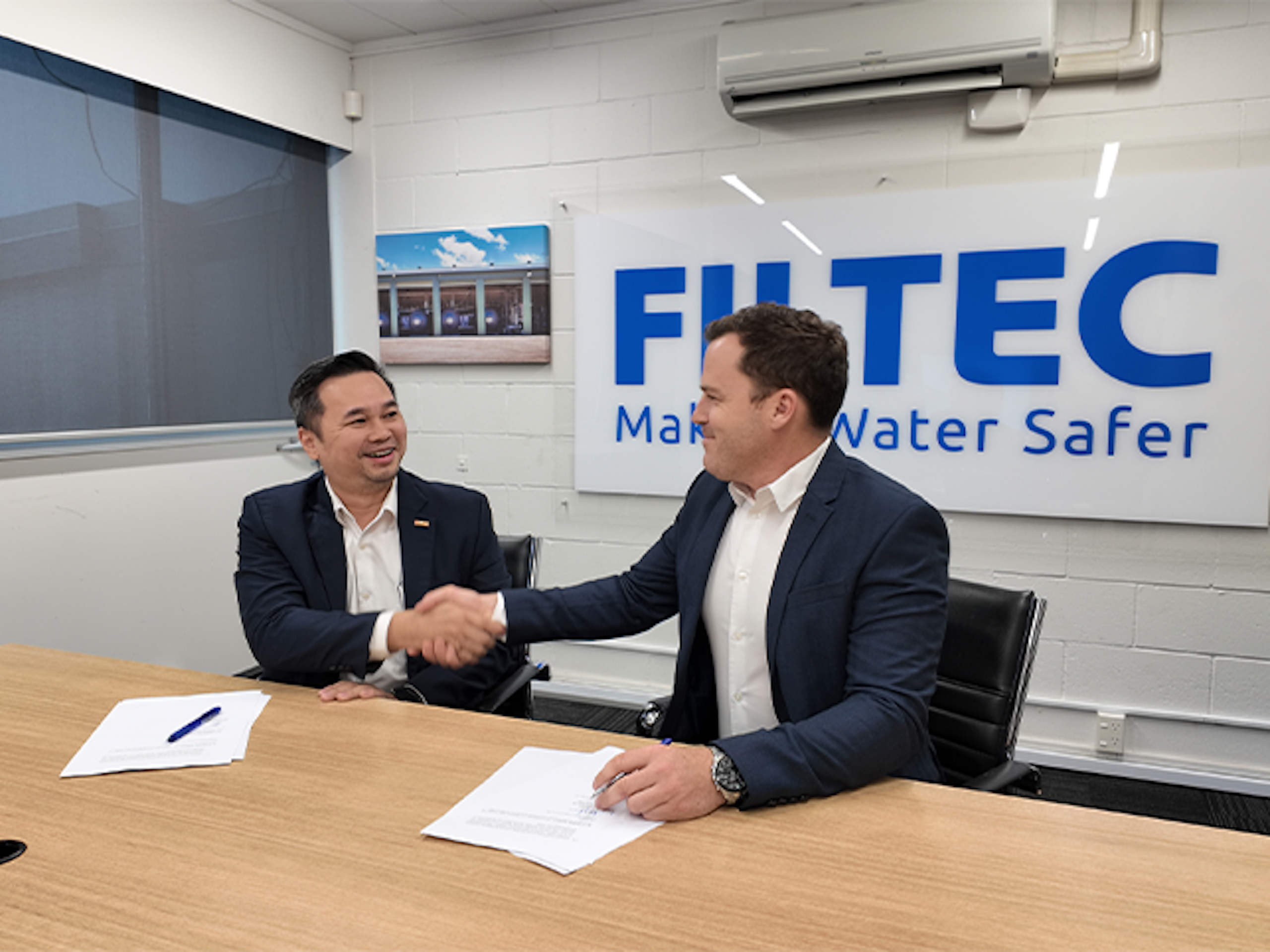 Filtec and Toray representatives shaking hands after signing a partnership agreement for ultrafiltration membrane technology