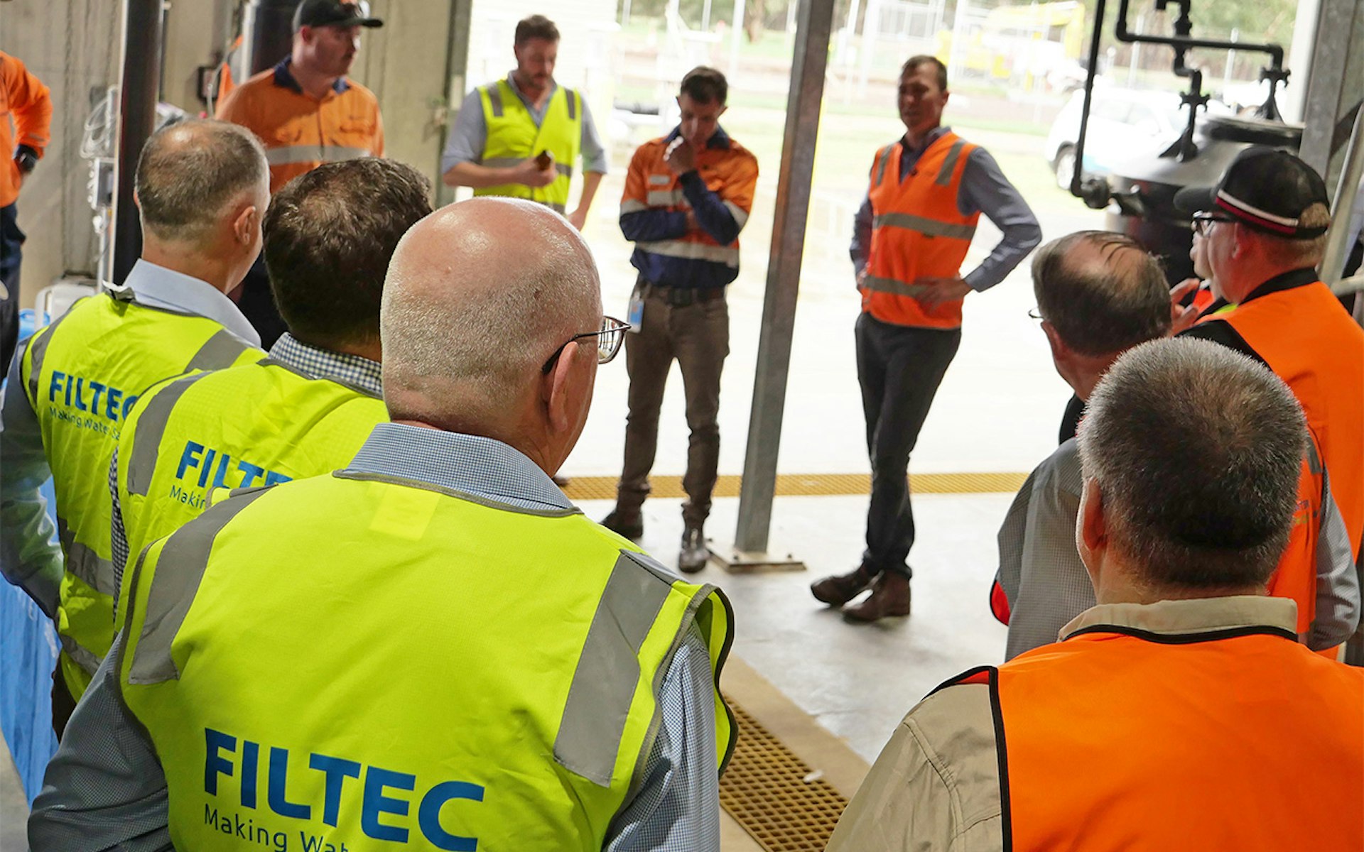 FILTEC team in high-vis vests listening to Coliban Water staff during Bendigo recycled water factory opening event
