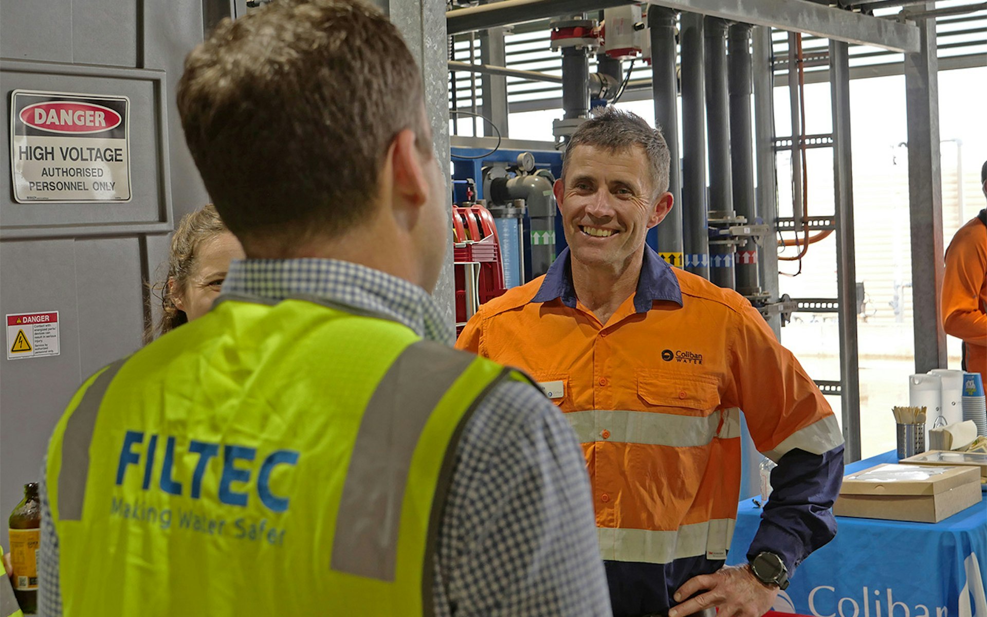 Coliban Water staff member speaking with FILTEC team during Bendigo recycled water factory opening event