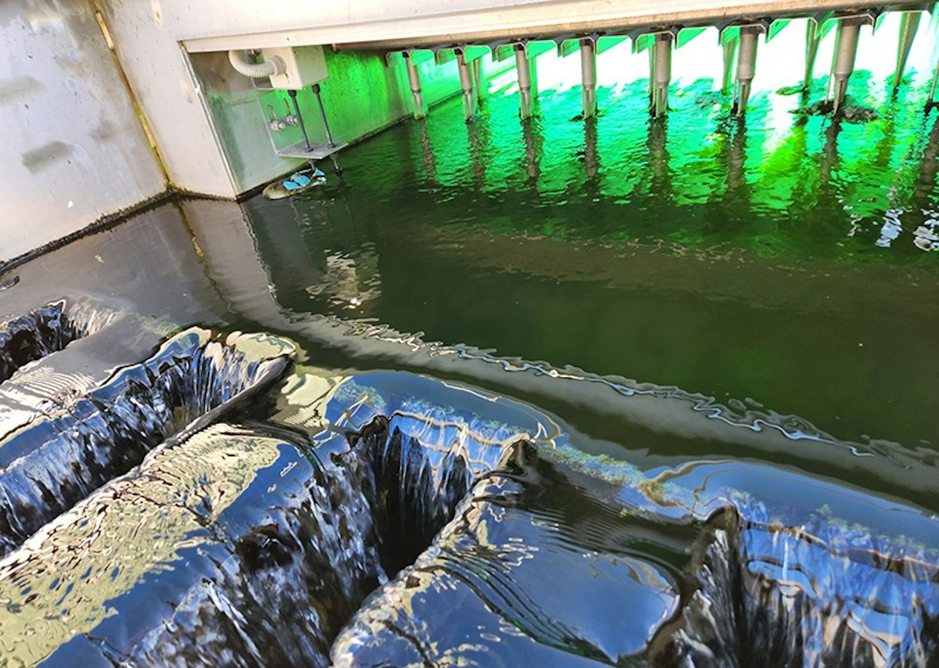 Treated wastewater flowing through UV disinfection infrastructure during reuse treatment