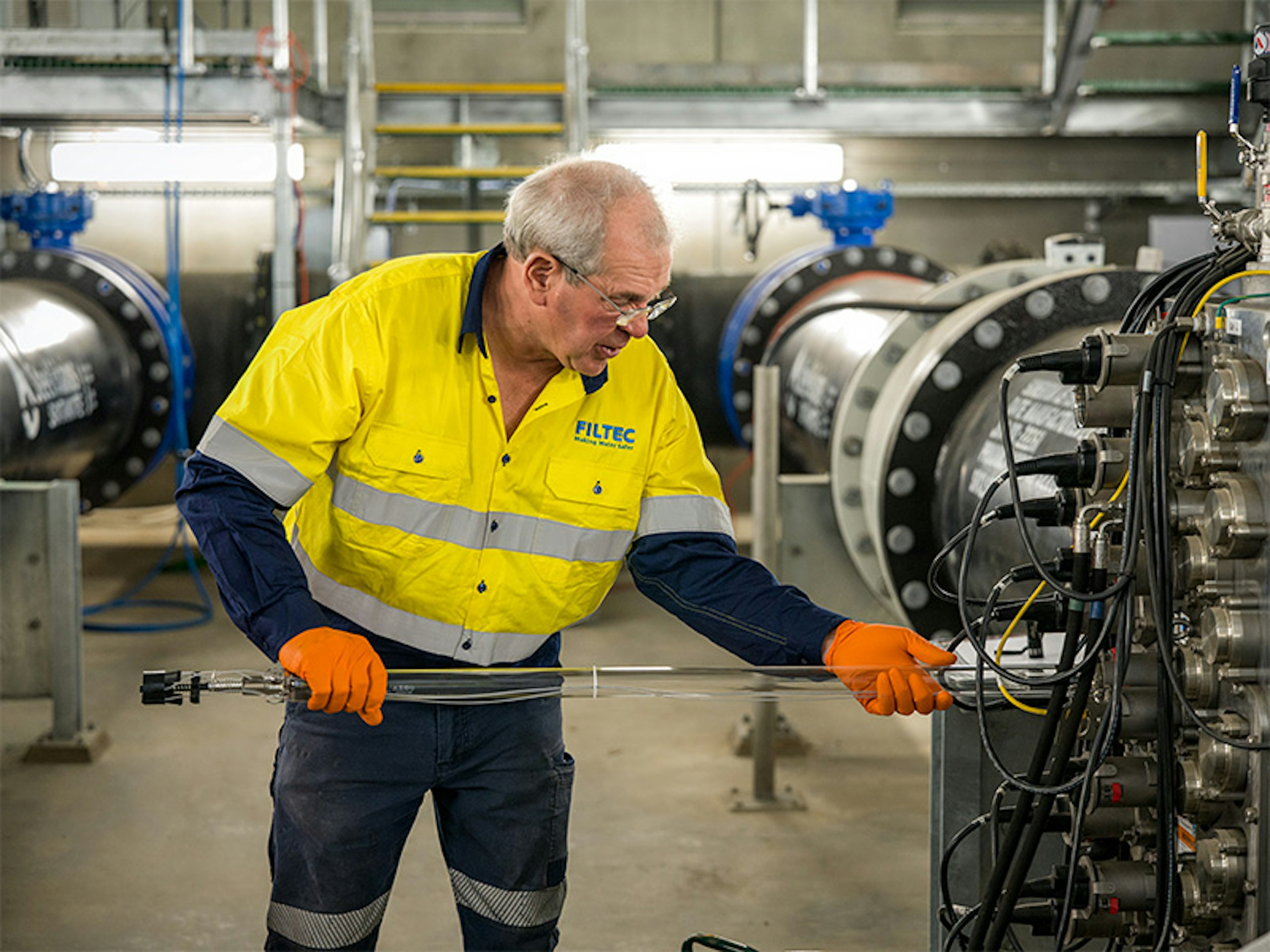 FILTEC technician removing a UV lamp during maintenance of a council water treatment system FILTEC technician removing a UV lamp during maintenance of a council water treatment system