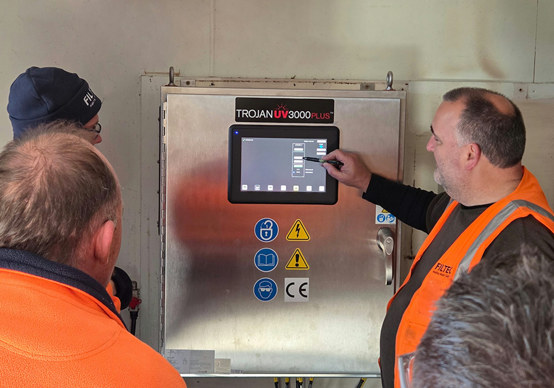 FILTEC specialist providing operator training on the TrojanUV3000Plus control system
