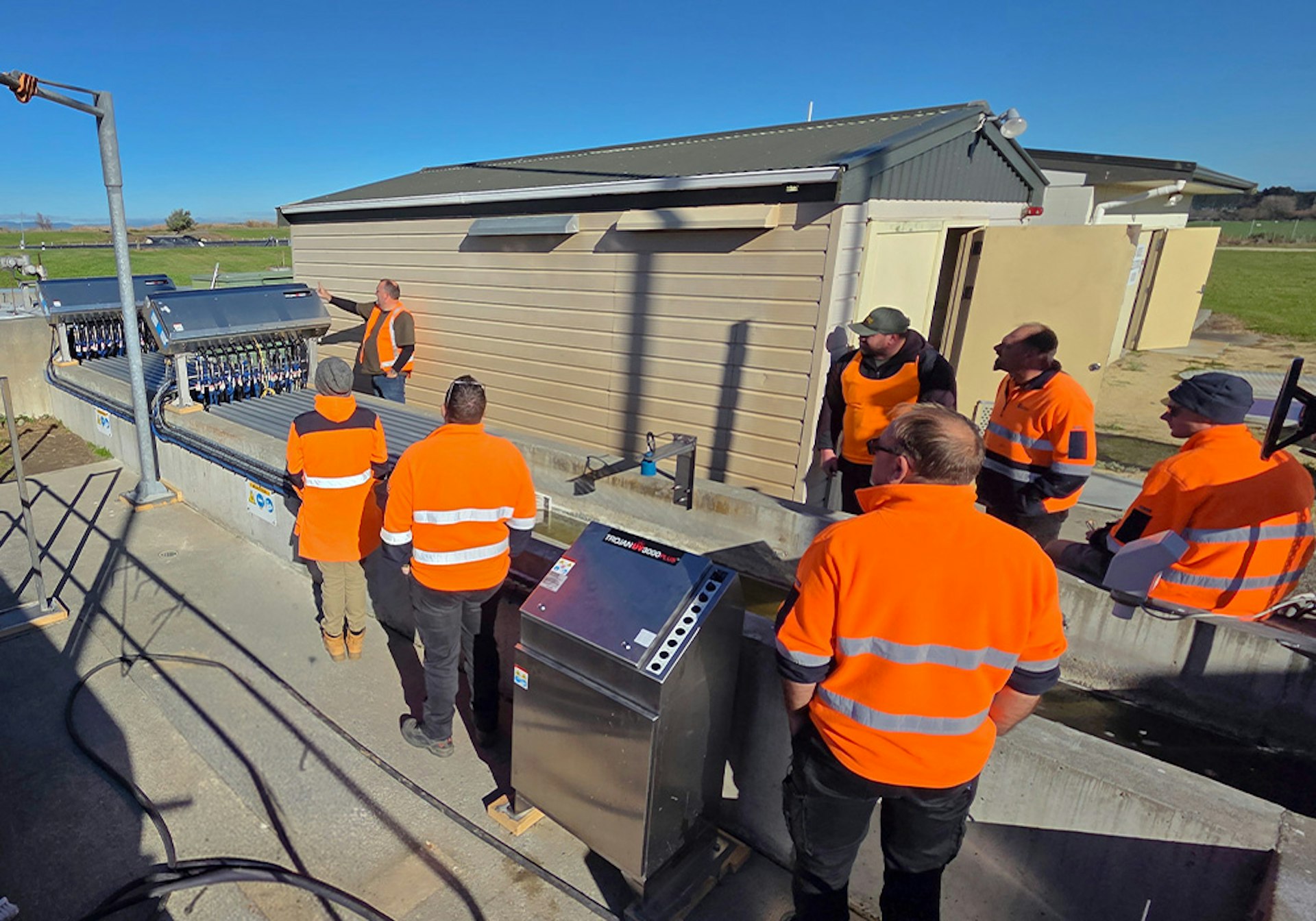 Plant operators receiving onsite training beside the new UV disinfection system