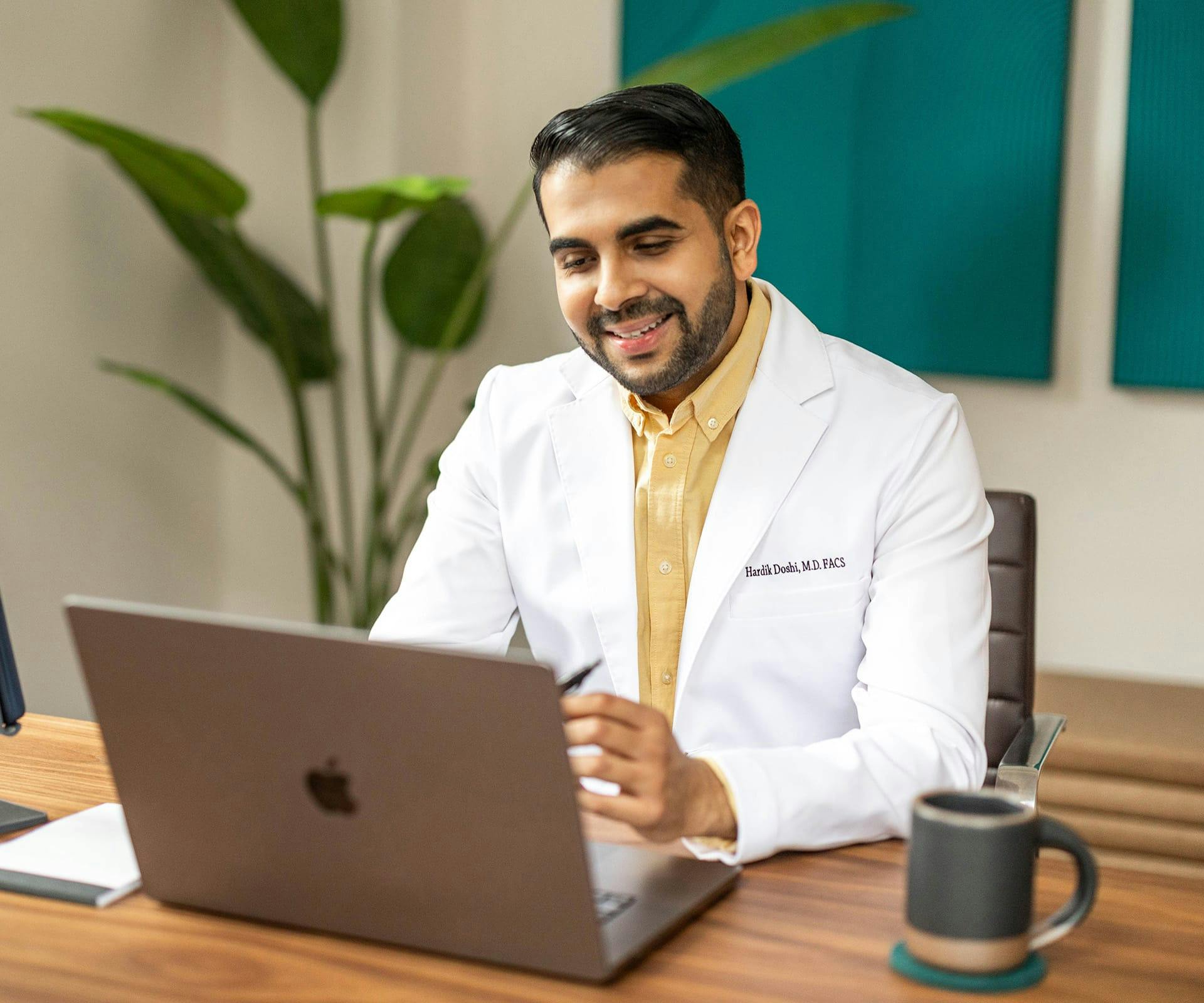 man on laptop smiling
