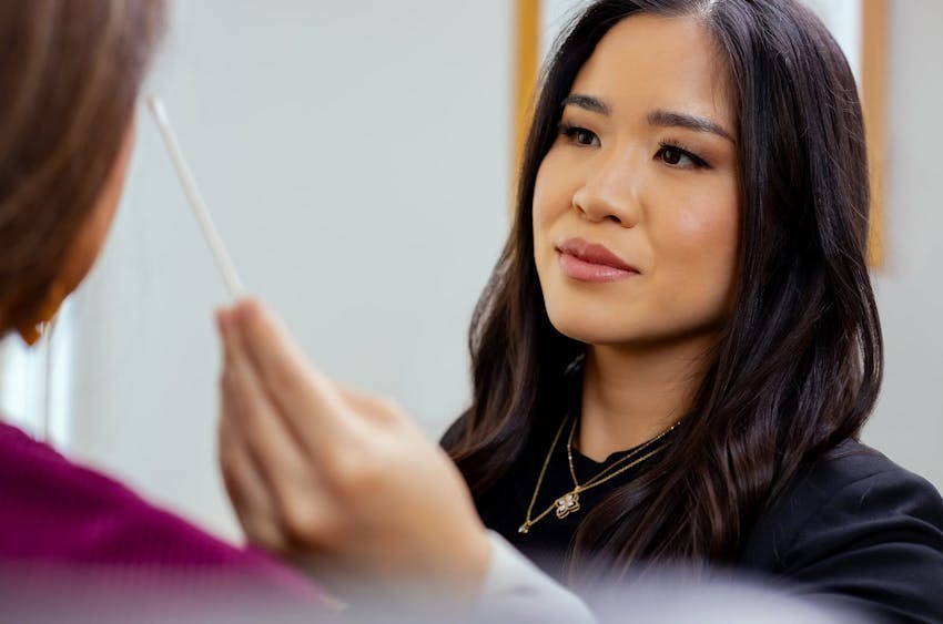 woman looking at another woman's face