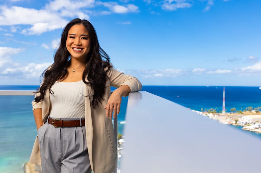 woman leaning on railing from top of building