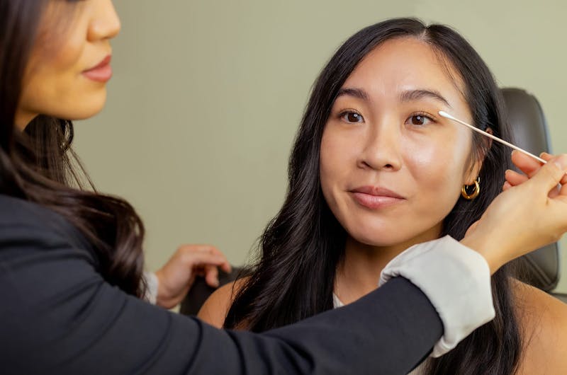 woman getting her eyelid examed by doctor