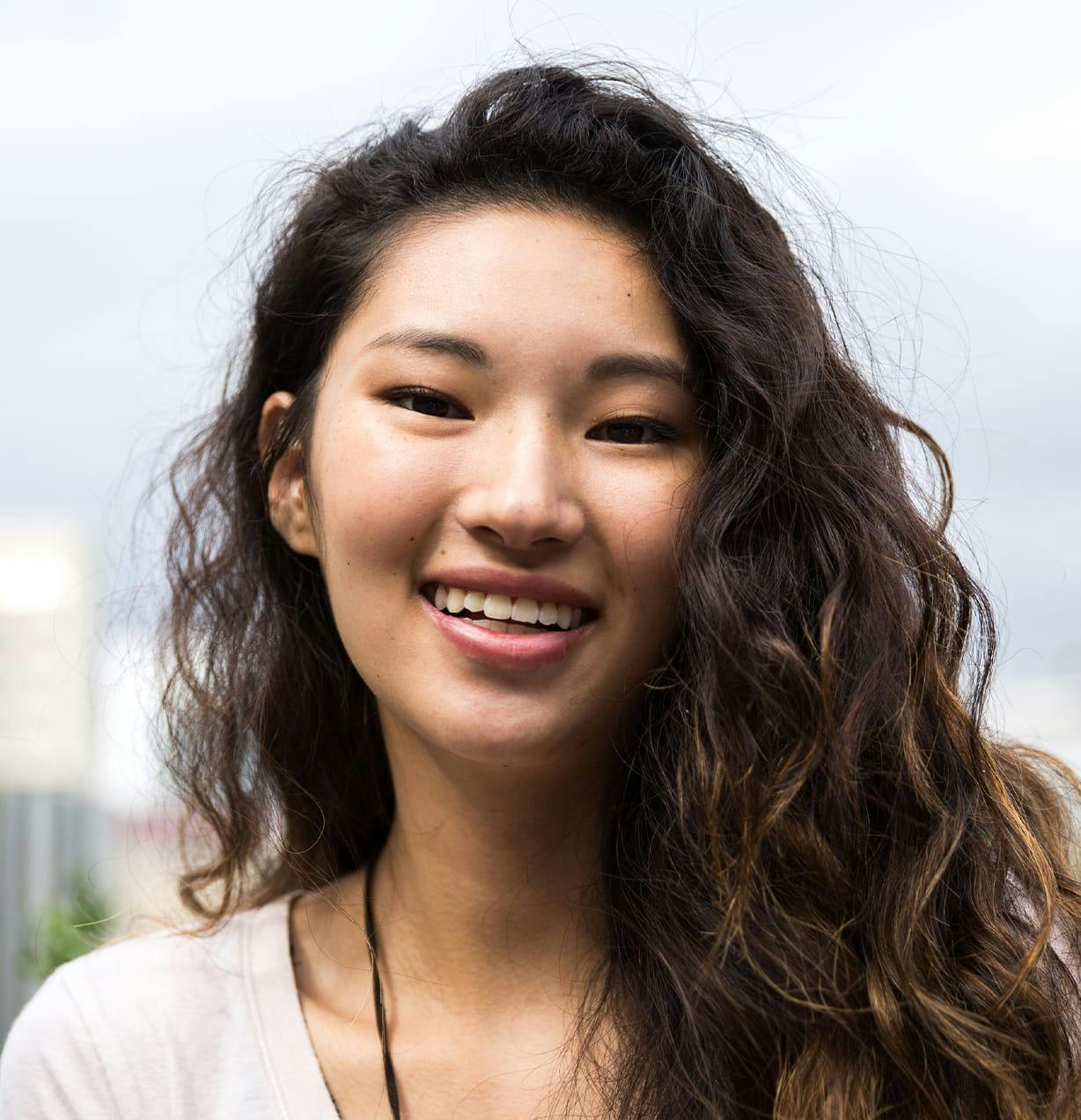 woman with wavy hair smiling