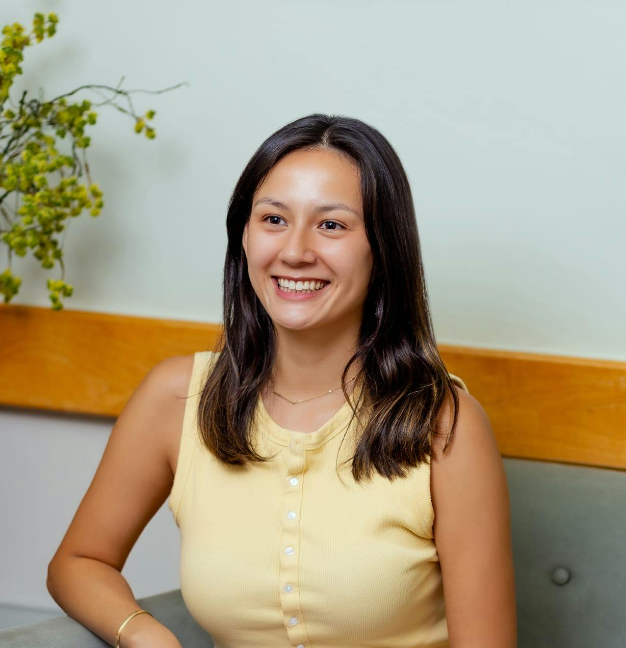woman in yellow top sitting on couch