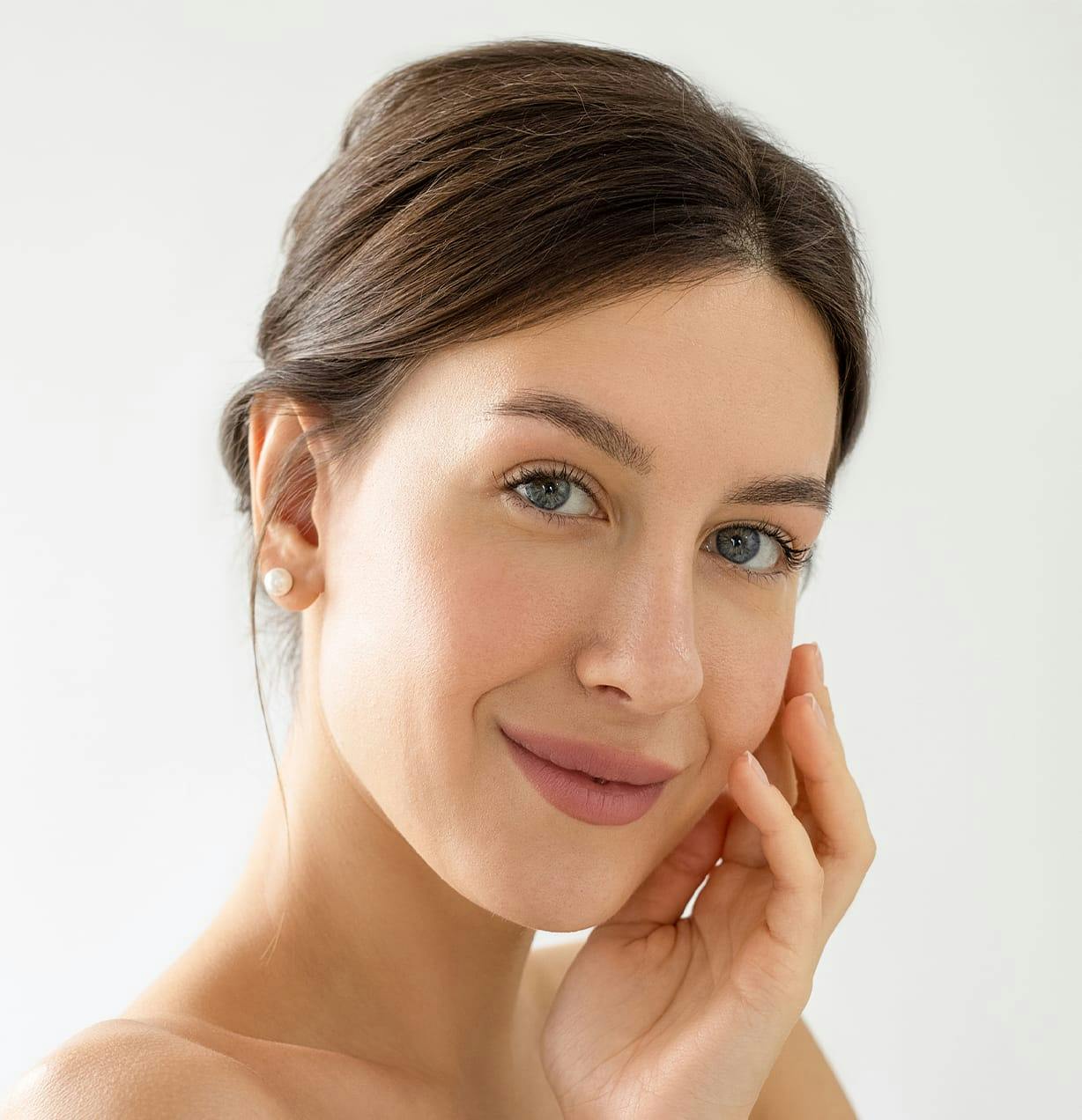 woman with her hand on a cheek with a smile
