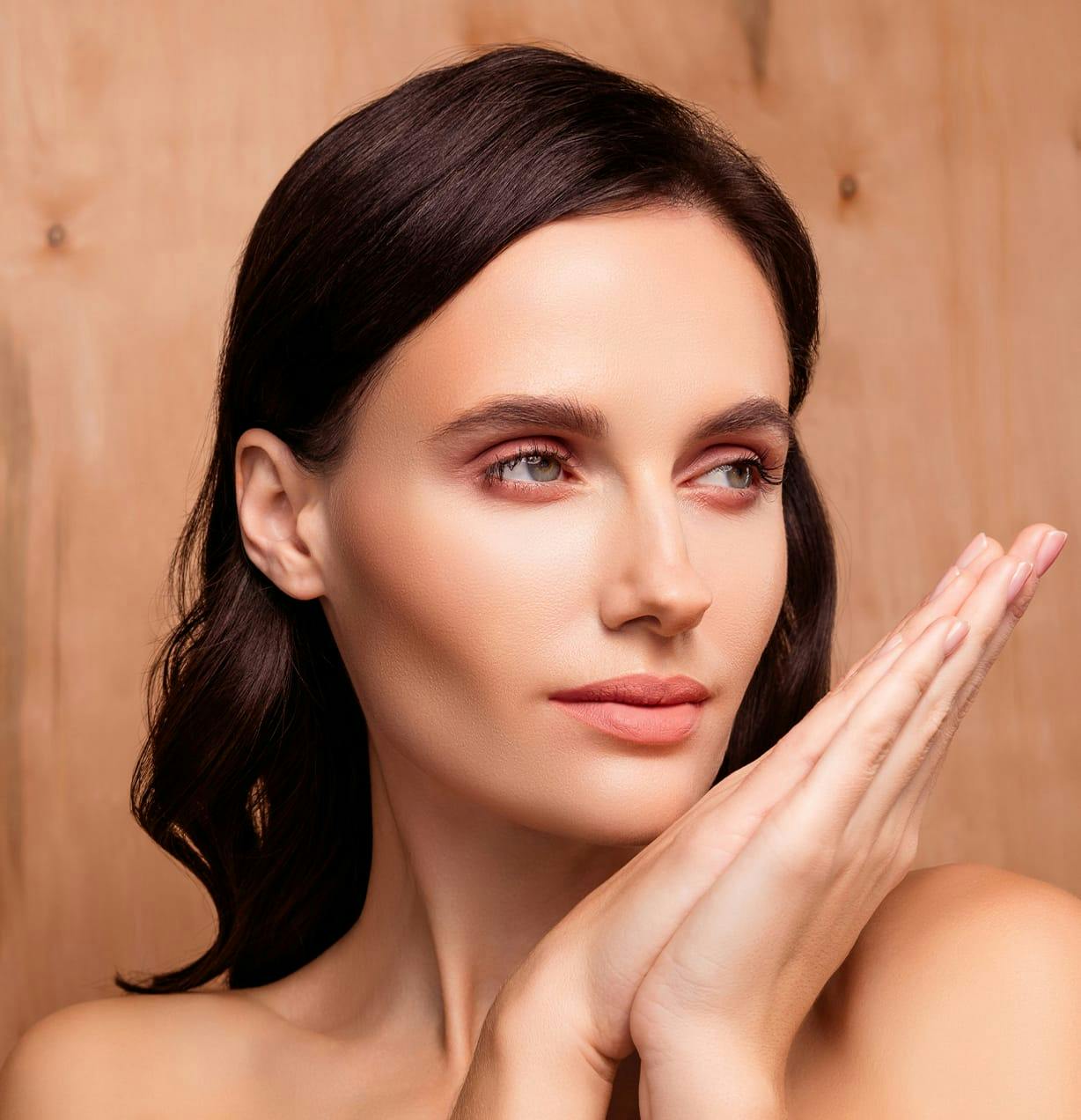 woman with her hands together pointing outwards