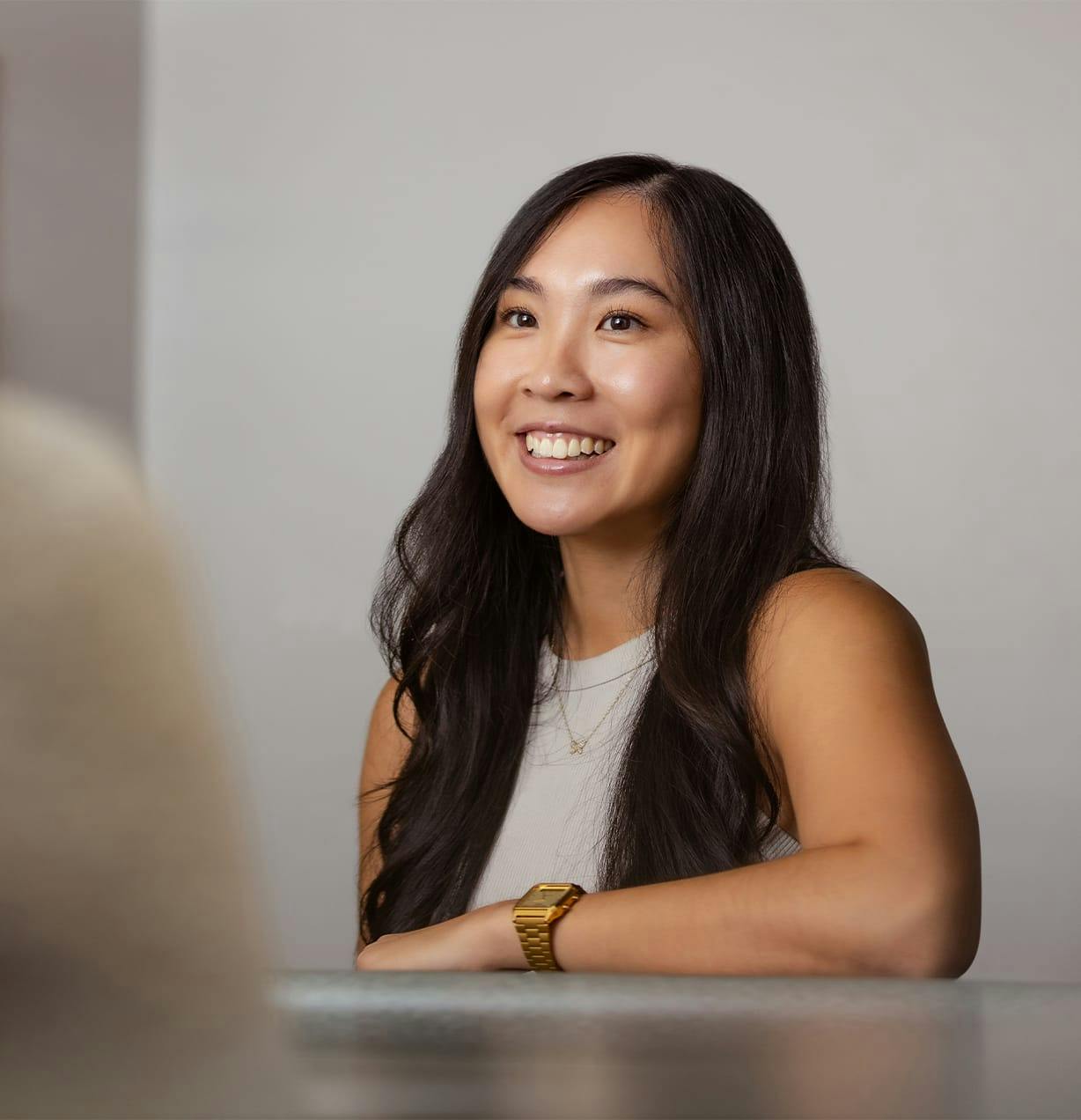 woman leaning on a table and smiling