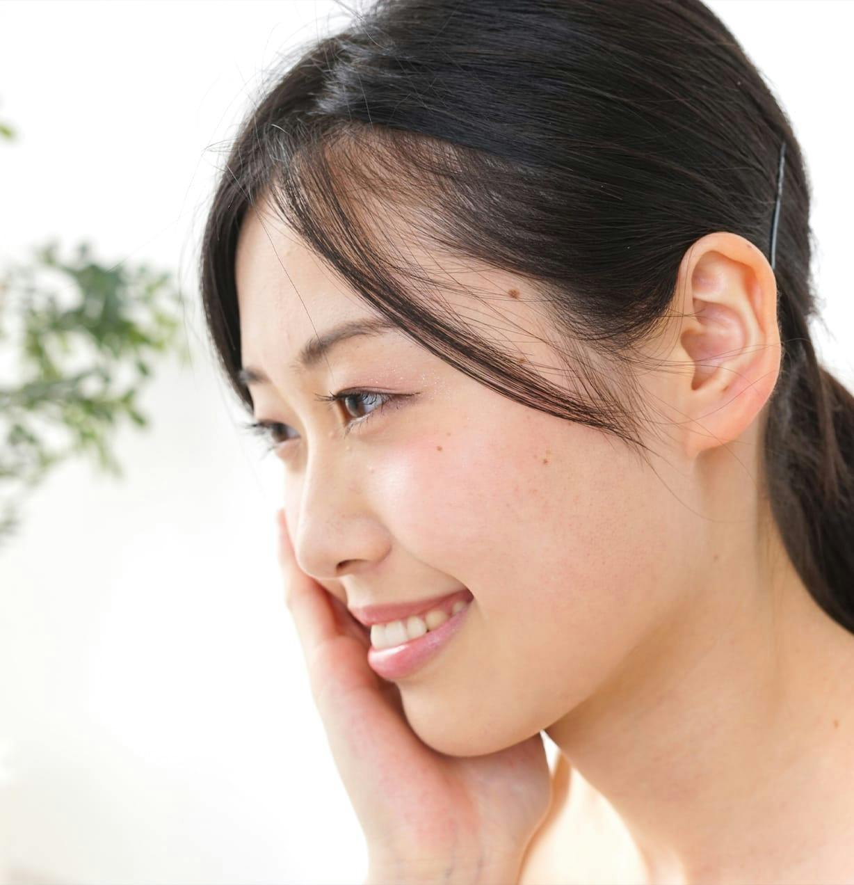 woman smiling with her hand on her cheek