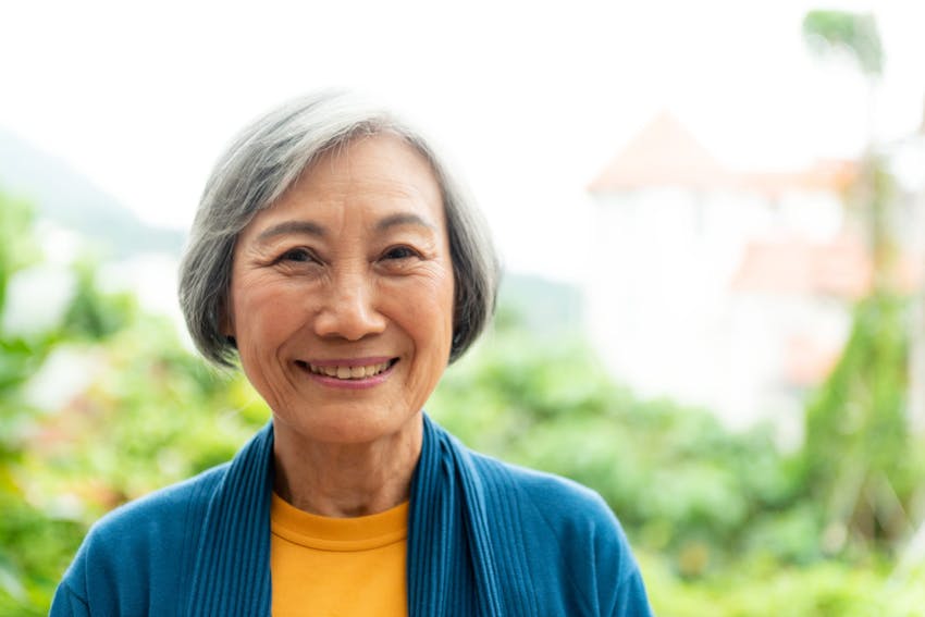 older woman in sweater smiling