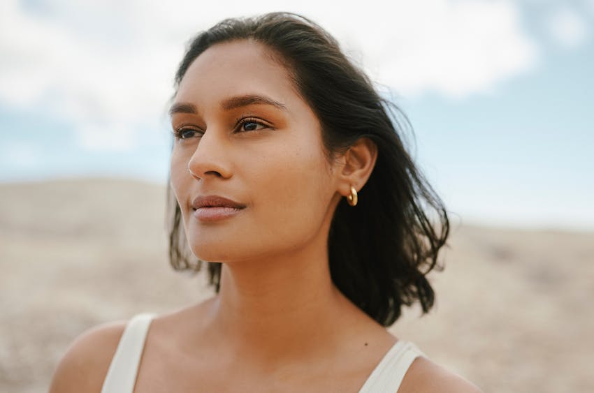 woman sitting in chair turned around with elbow on head of chair