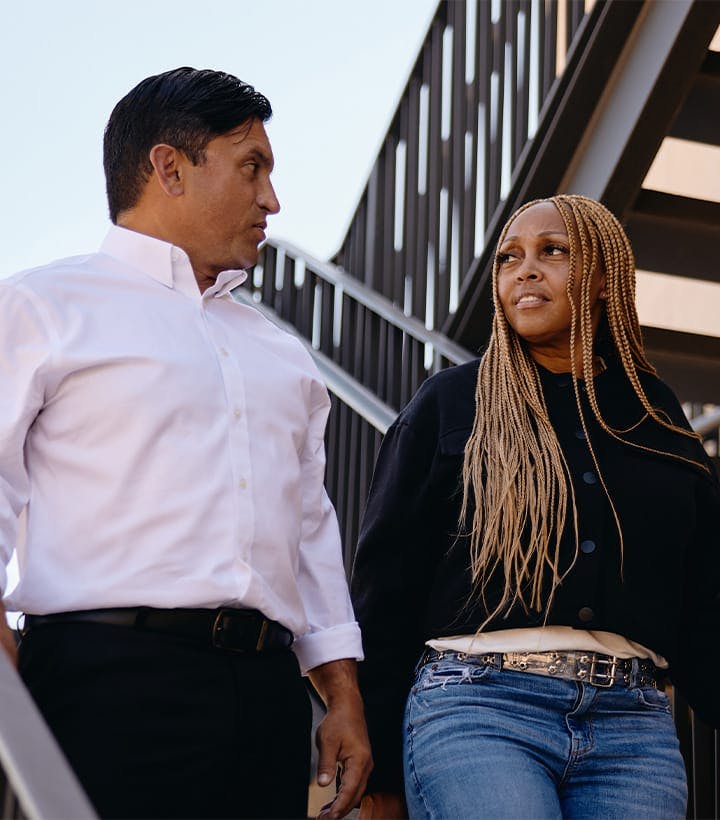 Fassold walking with client down stairs