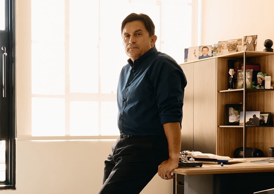 attorney leaning against a desk