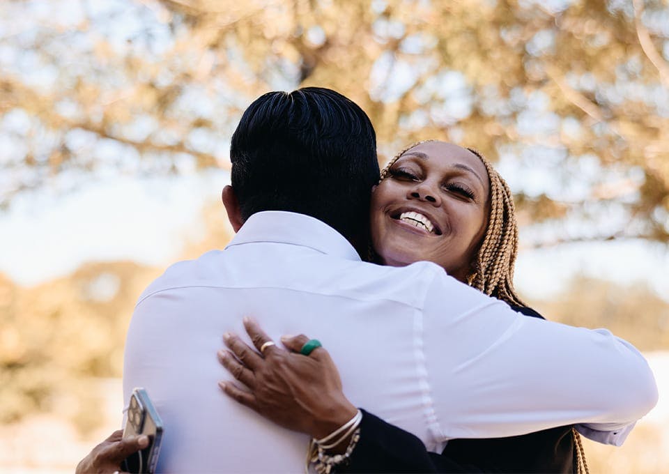 Fassold and client hugging