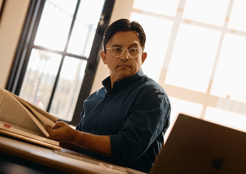 Fassold looking at a law book