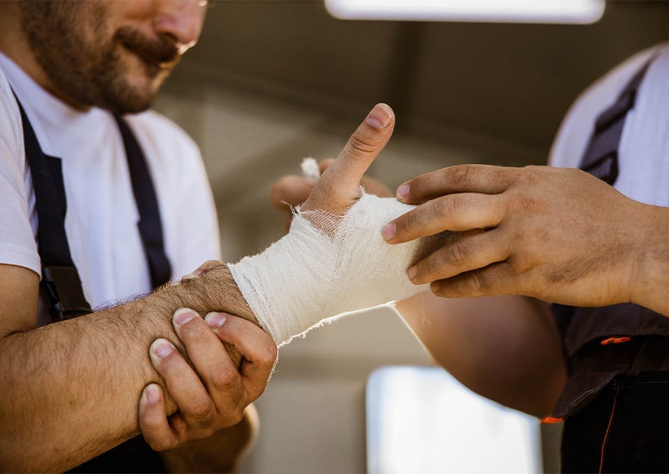 man getting his hand bandaged