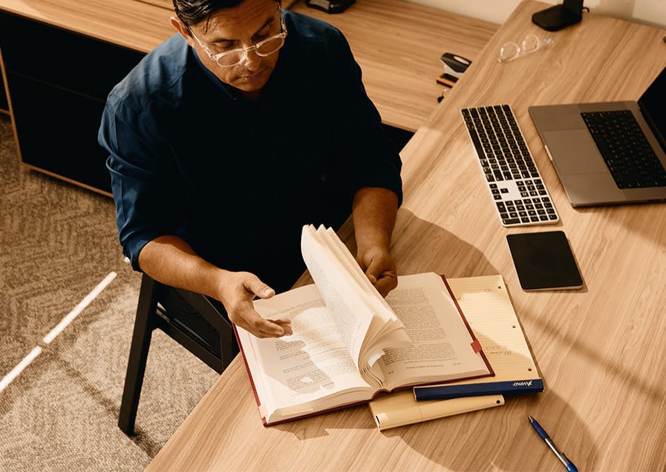 Fassold looking through a law book