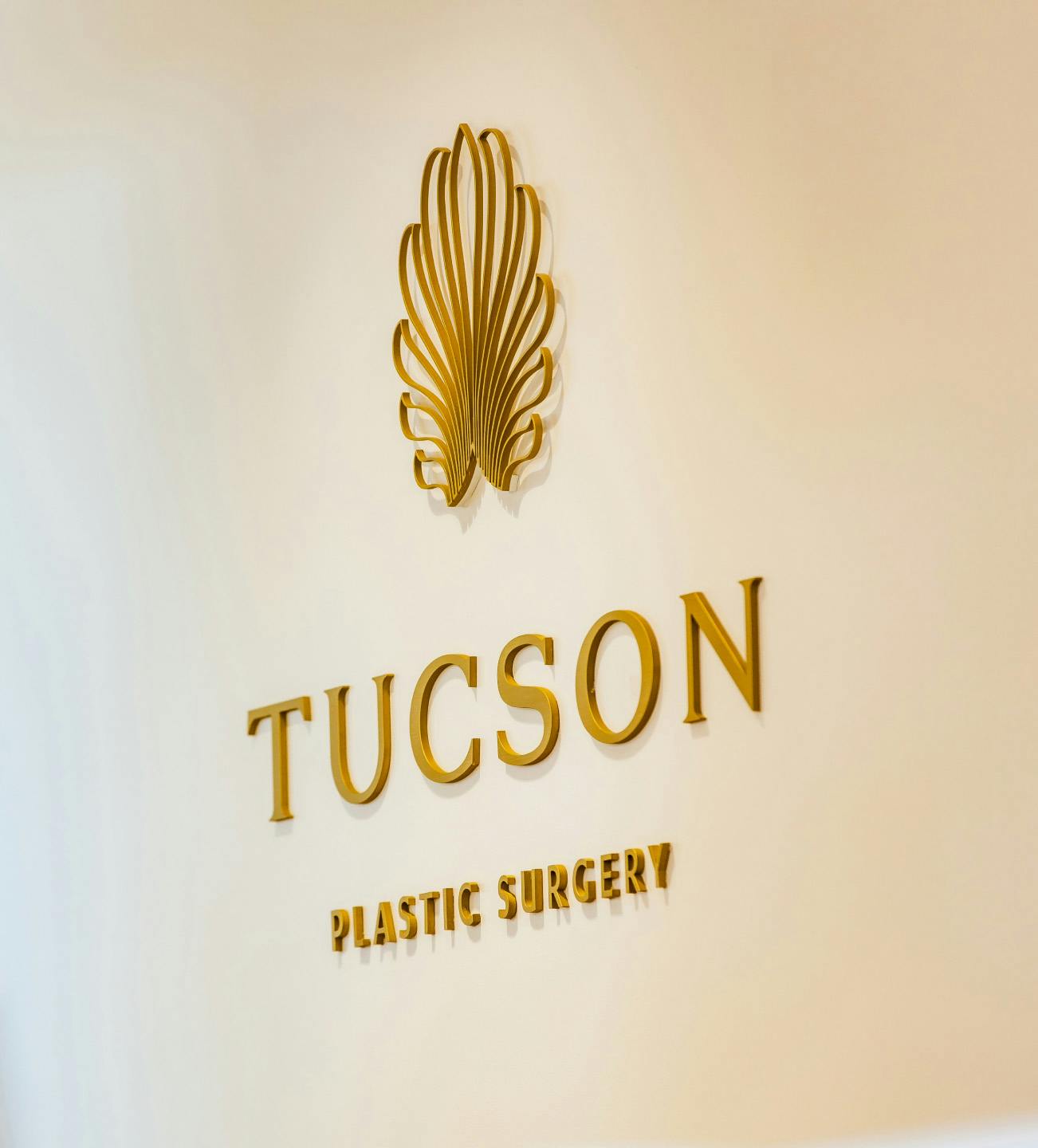 Tucson Plastic Surgery logo on a wall