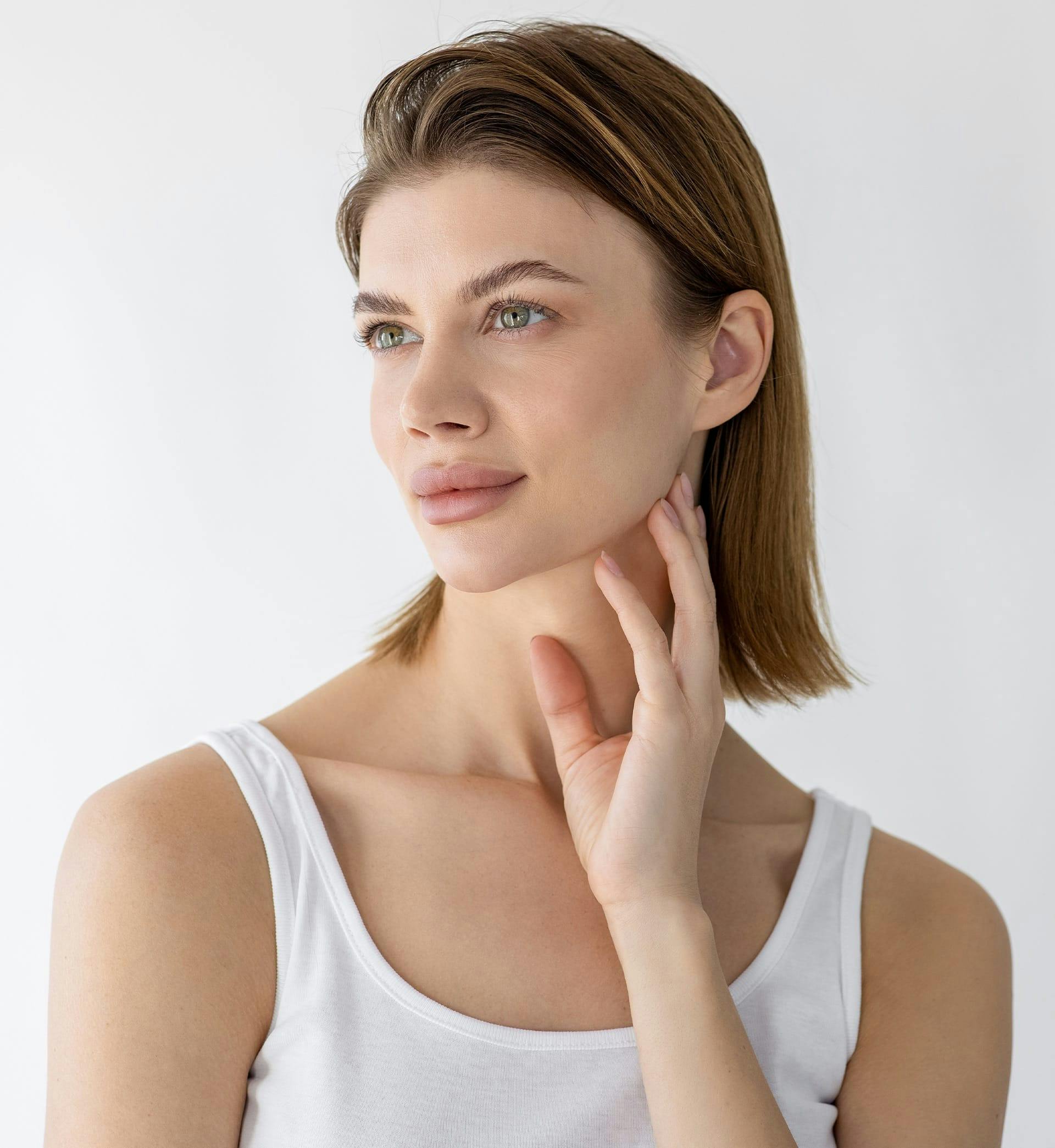woman posing in white tank top