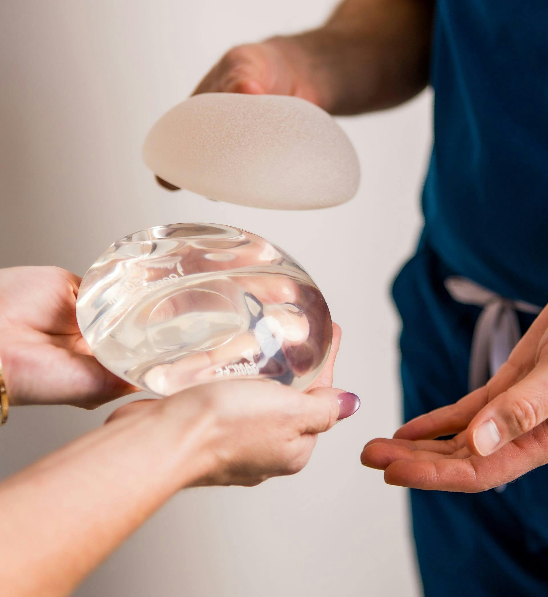 A hand holding an implant