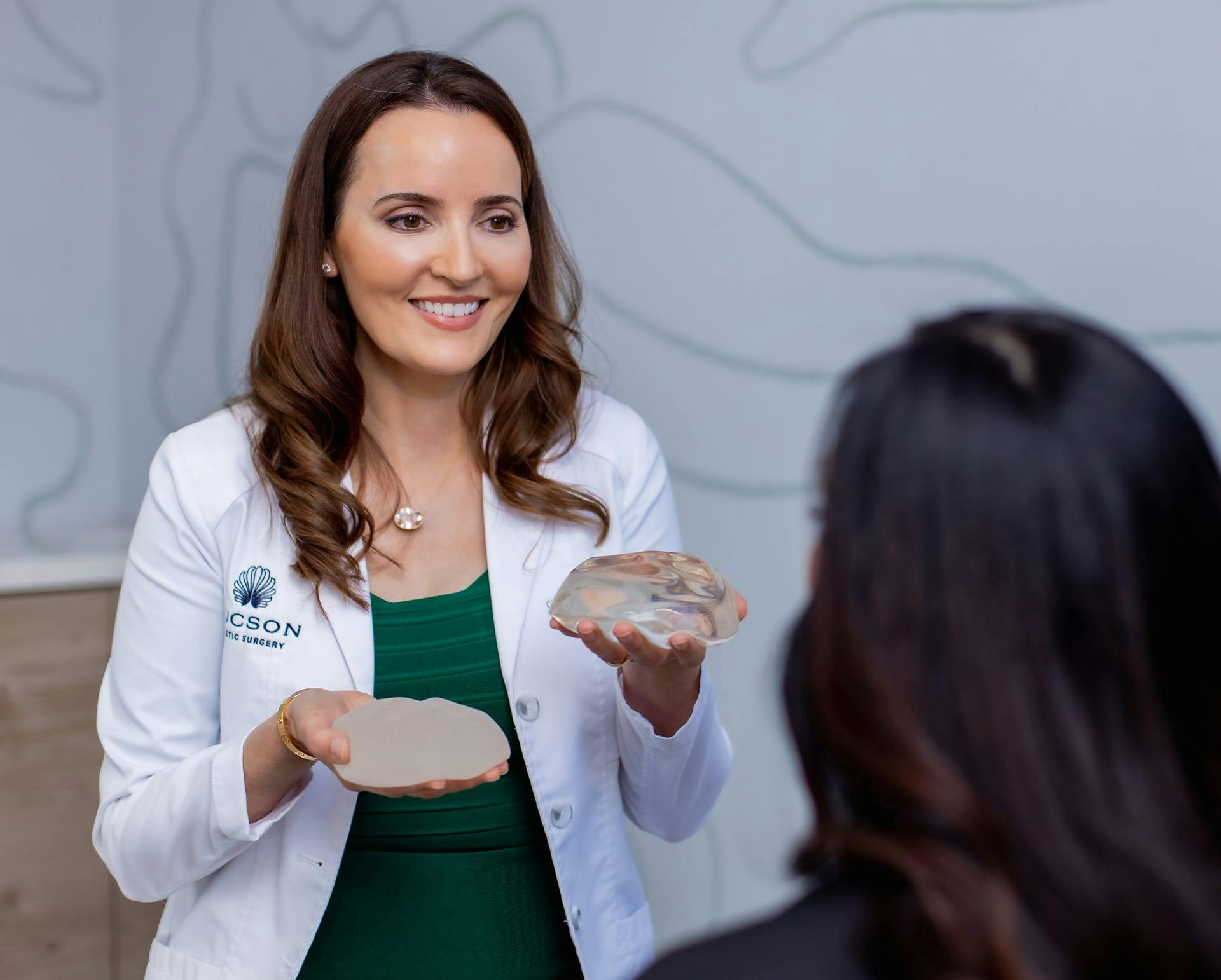 doctor showing a patient breast implants