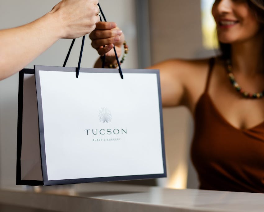 woman being handed a shopping bag