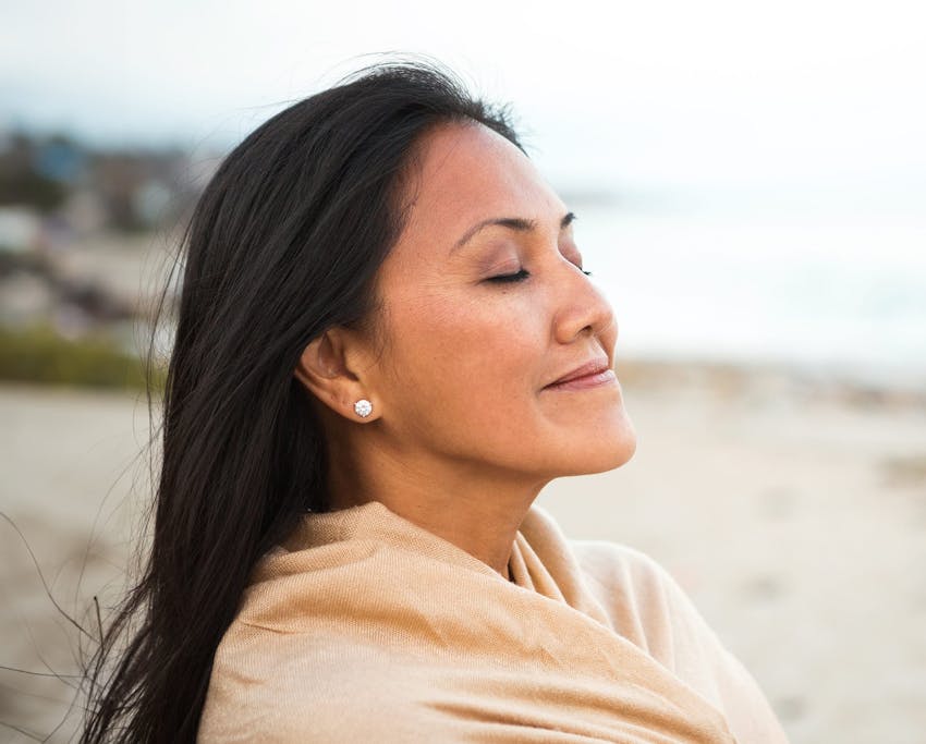 woman wearing a scarf at the beach