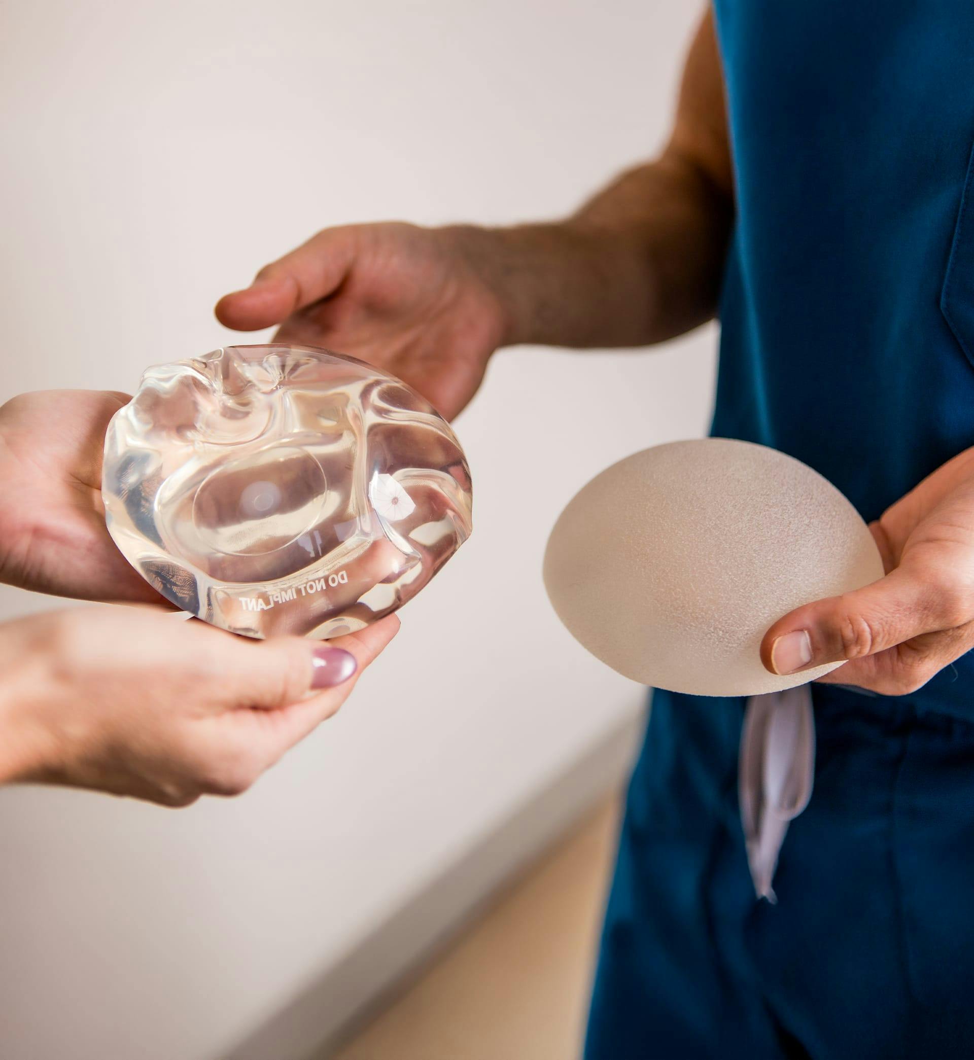 doctor holding breast implants