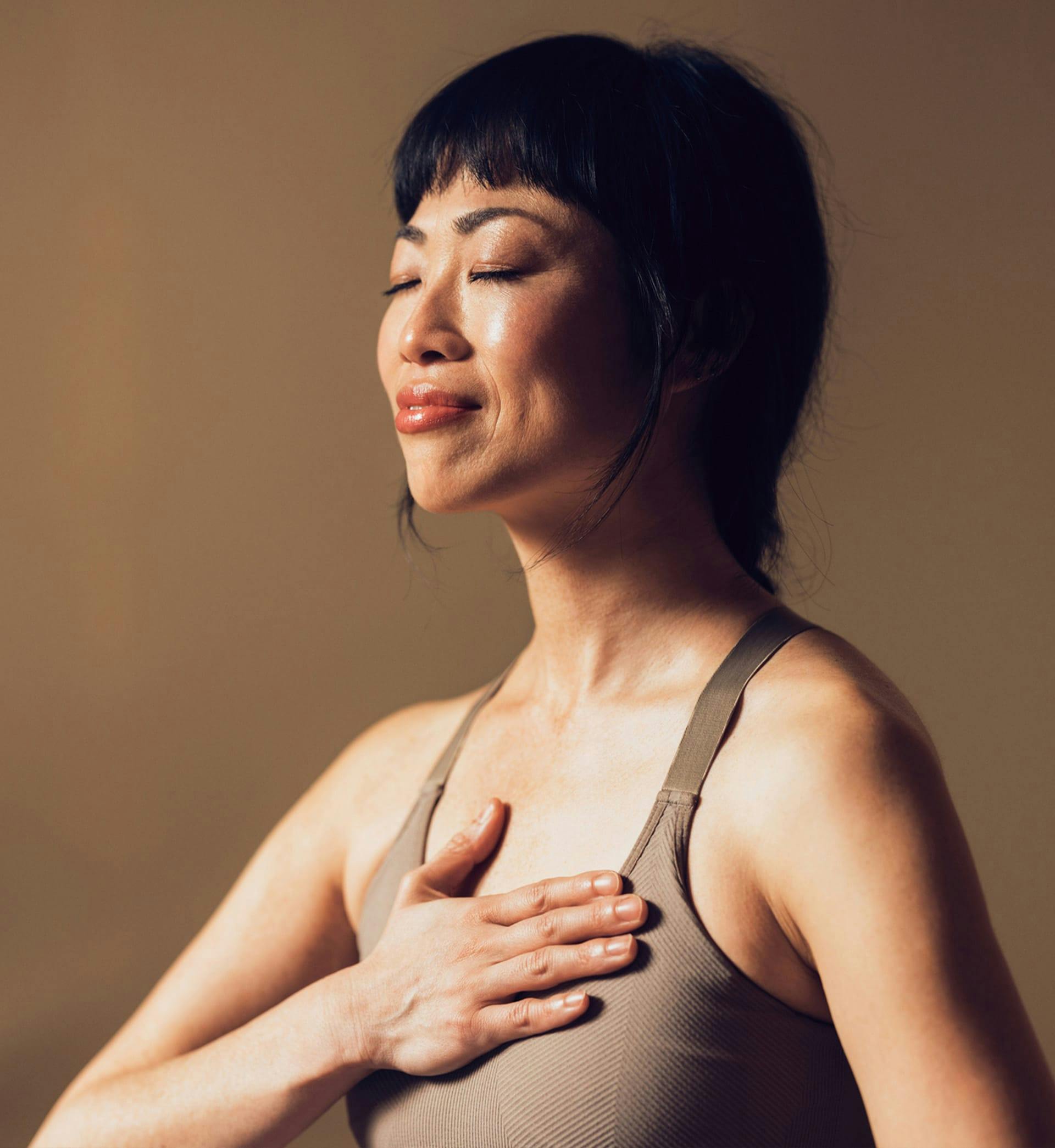 woman touching her chest