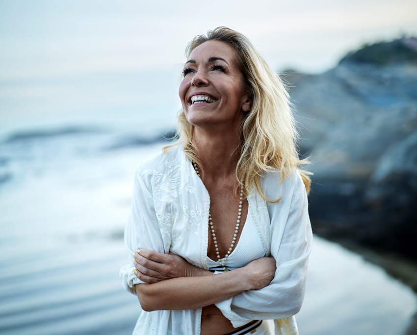 woman at the beach smiling