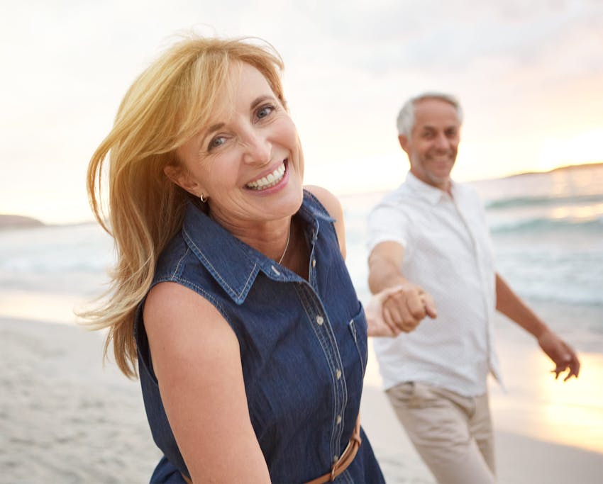older couple walking along the beach