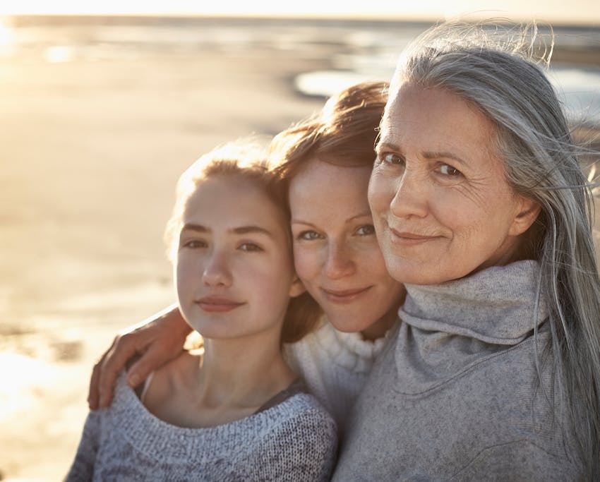 three generations of women posing for a photo