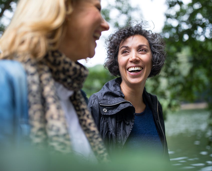 two women outside talking and laughing