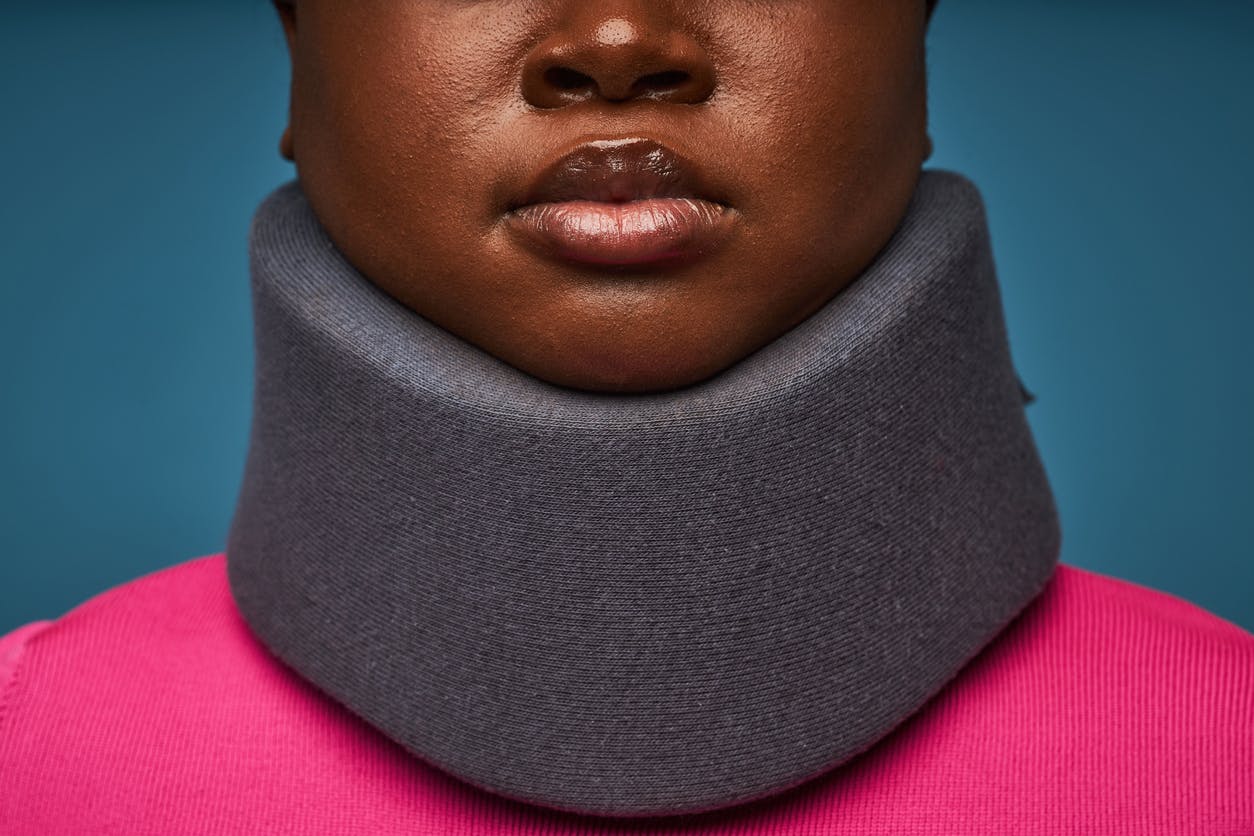 woman with a neck brace after sustaining neck injuries