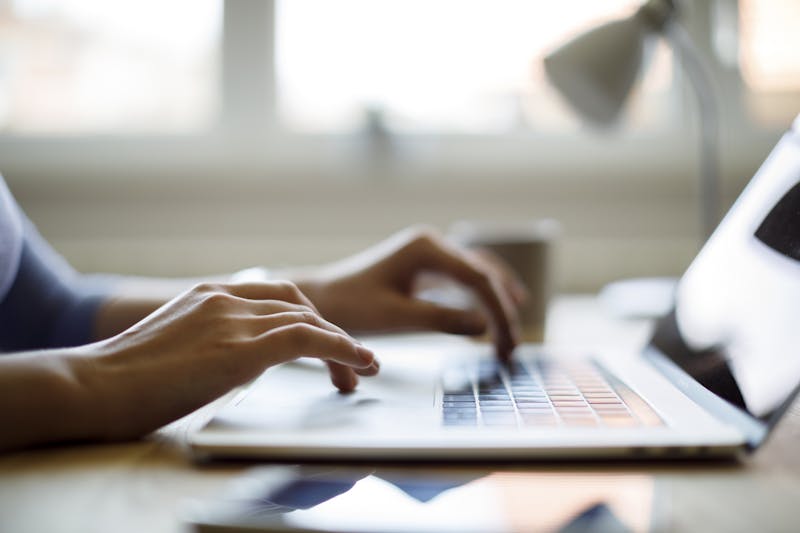 Woman typing on a laptop